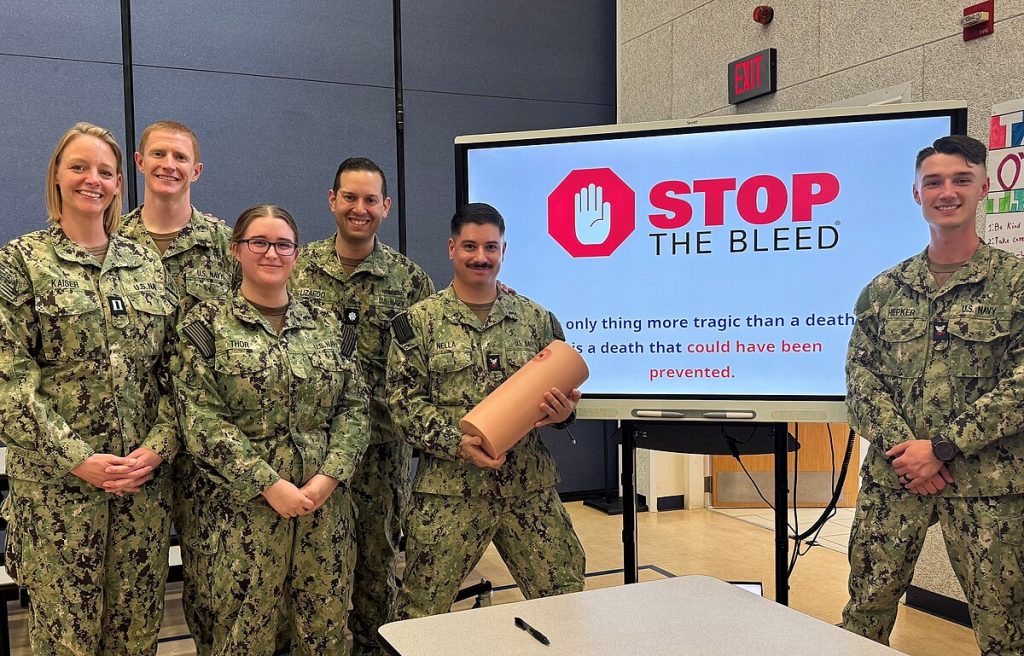 A group of naval officers poses for a stop the bleed event