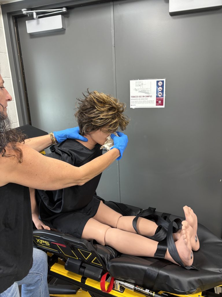 "Nosebleed" by Mark Schwartz, Chippewa Valley Technical College is licensed under CC BY-NC 4.0 Demonstration of of a simulated upright image with a slight forward tilt during a nosebleed