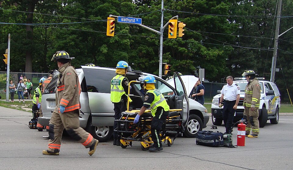 Paramedics are extracting a car accident patient from their vehicle