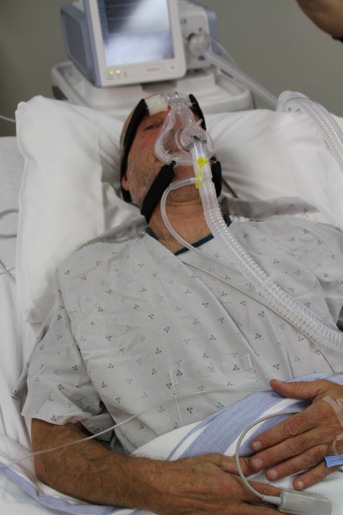 A simulated patient wearing a bi Pap mask