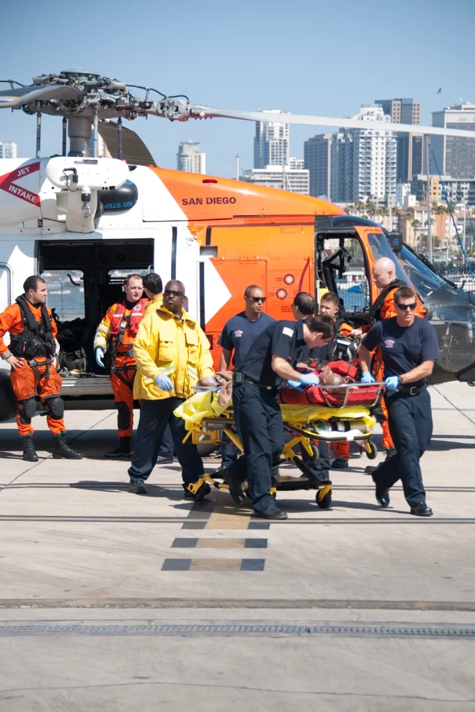 "Coast Guard Sector San Diego medevacs burn victim" by Petty Officer 1st Class Henry G. Dunphy is in the Public Domain. The appearance of U.S. Department of Defense (DoD) visual information does not imply or constitute DoD endorsement. A patient is loaded into a helicopter for transport