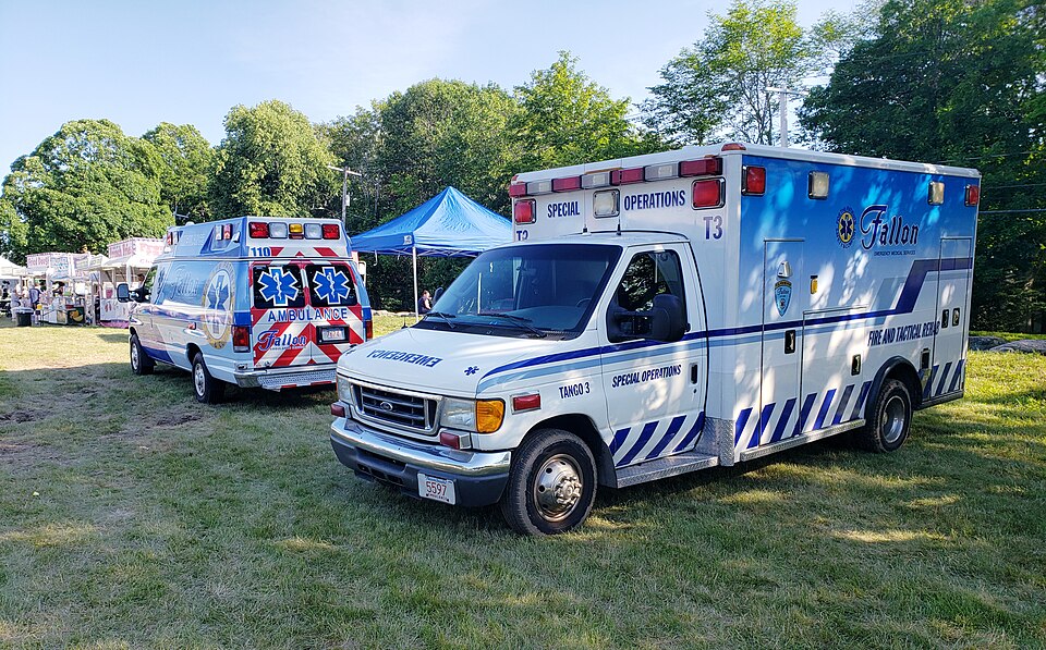 "Fallon_Ambulance_at_Milton_Music_Festival" by Mangocove is licensed under CC BY-SA 4.0 Ambulances parked at a music festival
