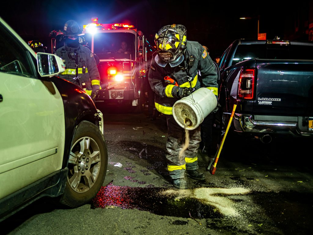 "pexels-joshua-santos-1174893-5564264" by Joshua Santos, via Pexels.com is licensed under CC0 A firefighter is pouring sand over a roadway spill