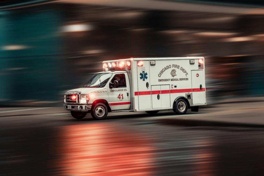 "pexels-nhp-co-456980180-15571631" by NHP&Co, via Pexels.com is licensed under CC0 ambulance that appears to be speeding due to blurred out background