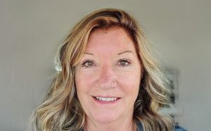A head shot of a woman smiling at the camera