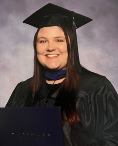 a young woman is dressed in graduation regalia and smiling at the camera