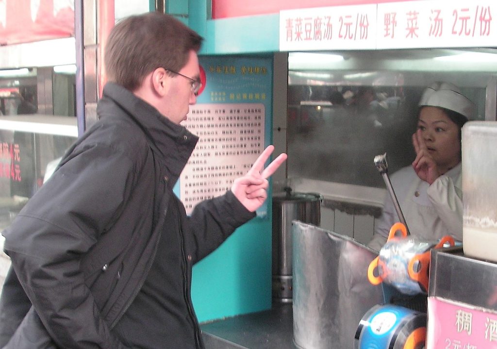 Two people are communicating through hand gestures
